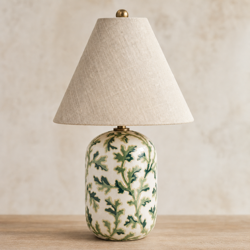 Table lamp with decorative green leaf pattern on a beige background