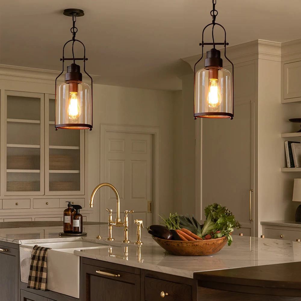 Modern kitchen with pendant lights, sink, and countertop with vegetables.