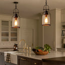Modern kitchen with pendant lights, sink, and countertop with vegetables.