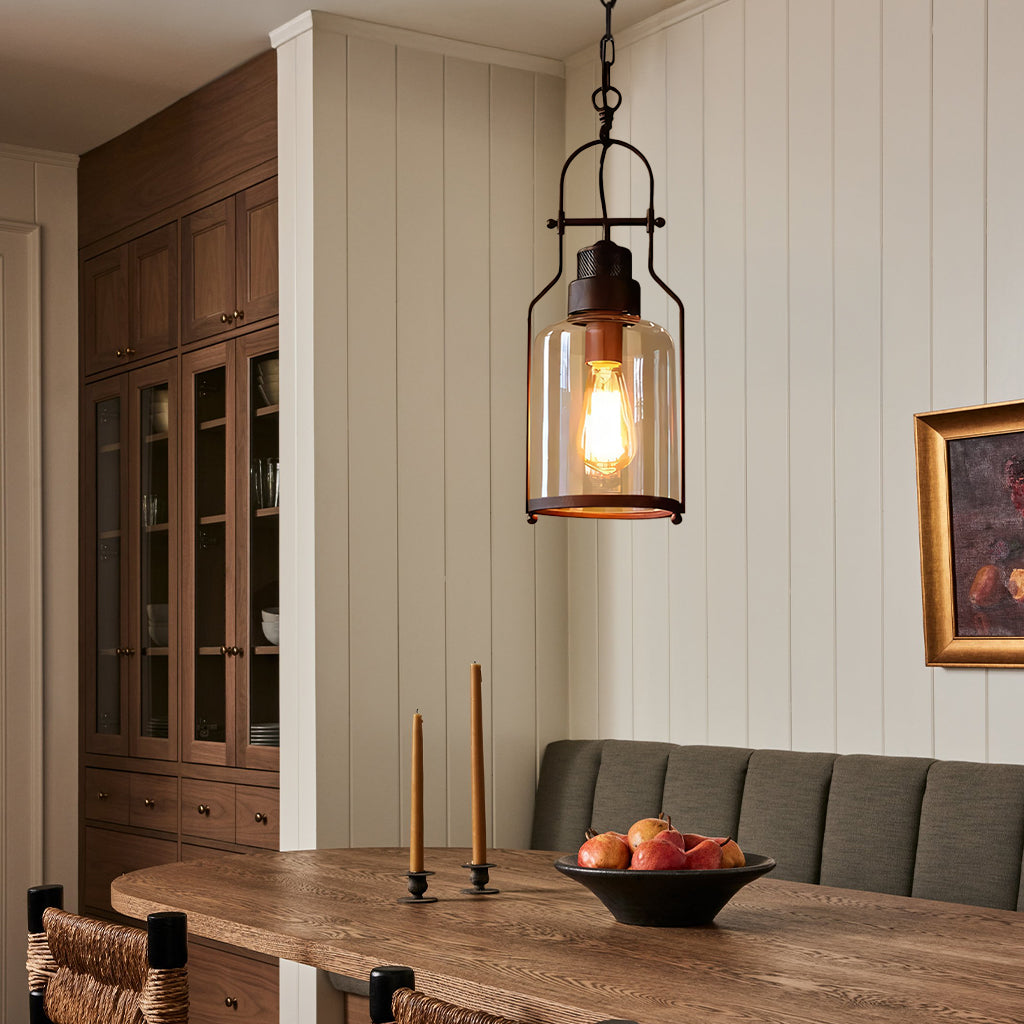 Dining room with wooden table, pendant light, and wall art.