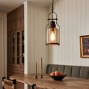 Dining room with wooden table, pendant light, and wall art.