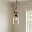 Pendant light fixture hanging in a room with a window in the background