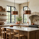 Modern kitchen with stone walls, wooden cabinets, and a white island.
