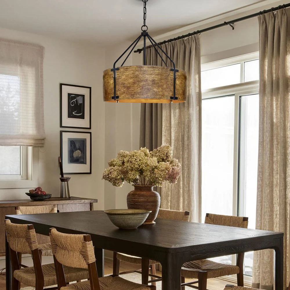 Dining room with wooden table, chairs, and a large pendant light.