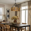 Dining room with wooden table, chairs, and a large pendant light.