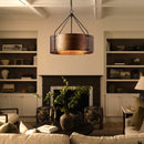 Living room with a chandelier, bookshelf, and fireplace.