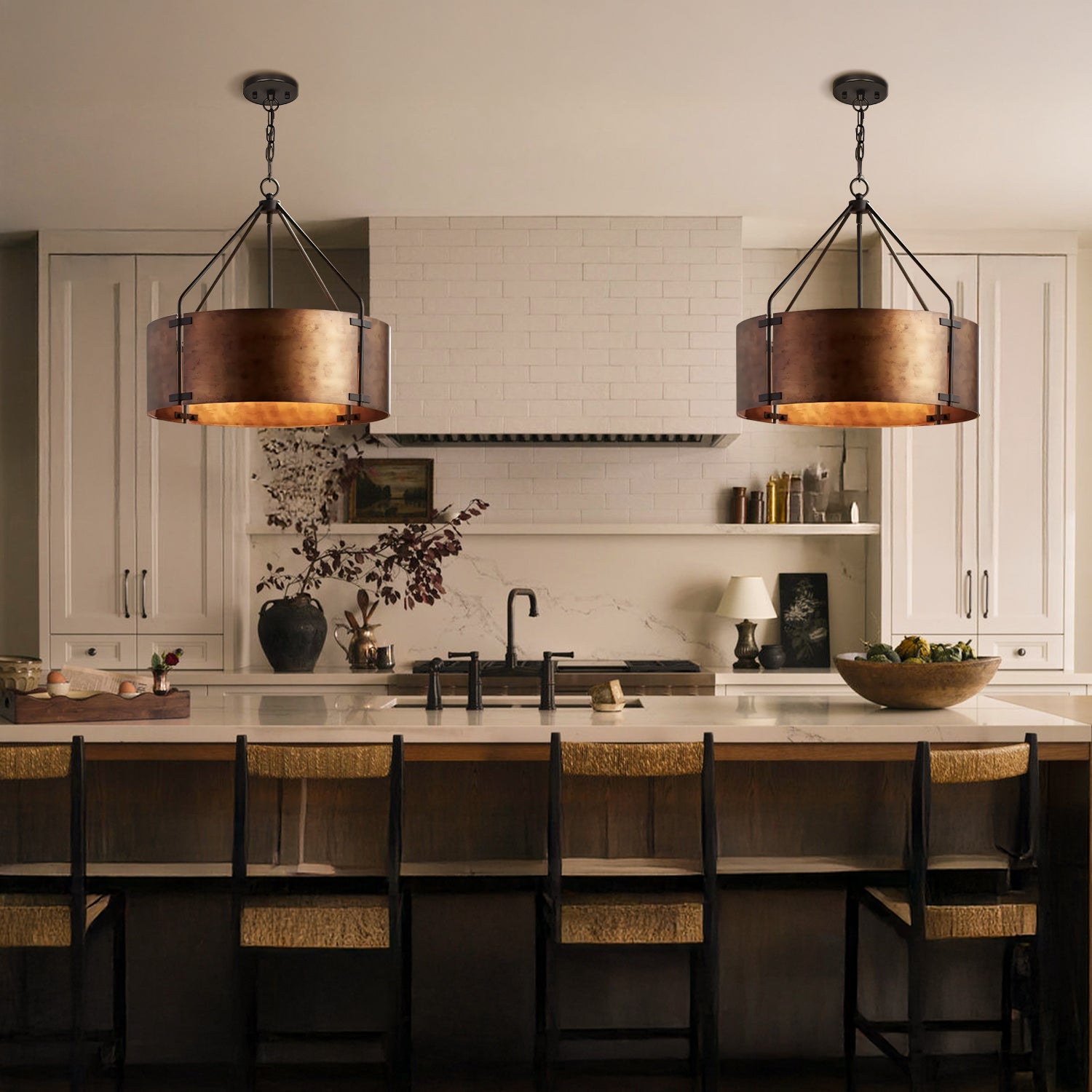 Modern kitchen with pendant lights, island, and chairs.