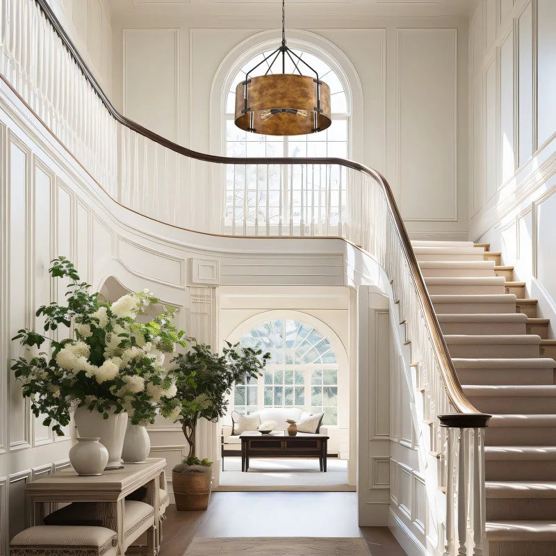 Staircase in a home with white walls, a chandelier, and a view into a living room.