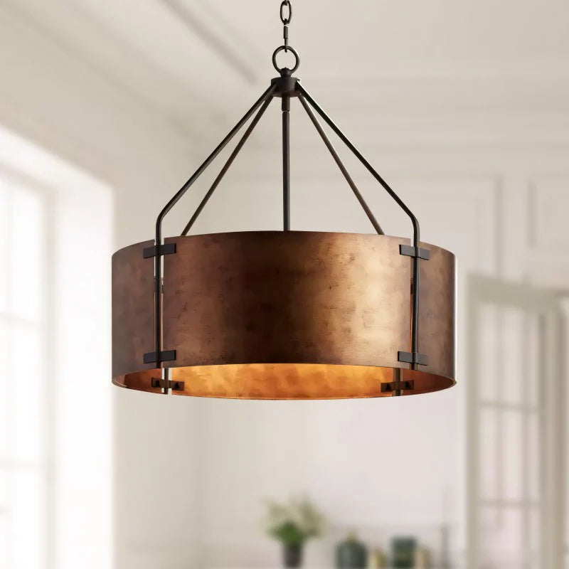 Bronze pendant light fixture hanging in a room with neutral decor