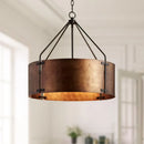 Bronze pendant light fixture hanging in a room with neutral decor