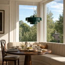 Dining area with a wooden table, chairs, and a large window view of trees.