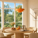 Dining room with a round table, chairs, and an orange pendant light.