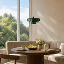 Modern living room with a round wooden table, chairs, and a large window with a view of trees.
