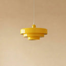 Yellow pendant lamp against a beige background