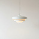 Modern pendant light with a white shade on a plain background