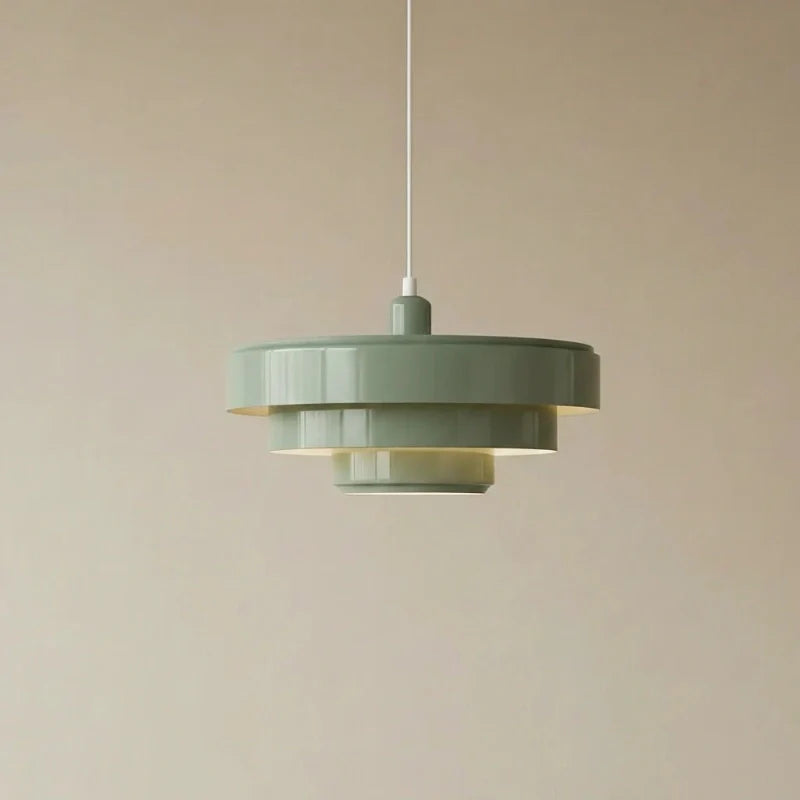Green pendant light against a beige background
