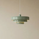 Green pendant light against a beige background
