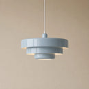 Gray pendant light against a beige background