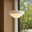 Modern pendant light hanging in a room with a window and outdoor view