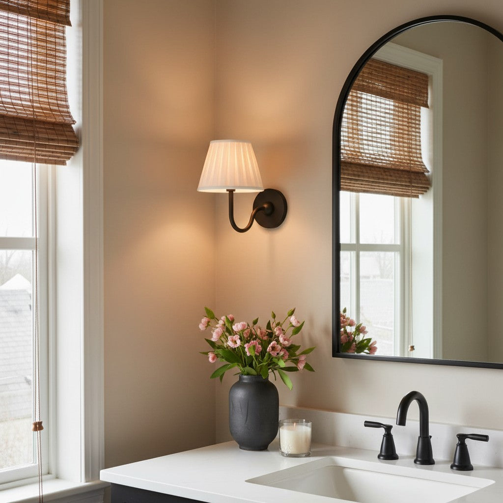 Bathroom interior with a sink, mirror, lamp, and flowers.