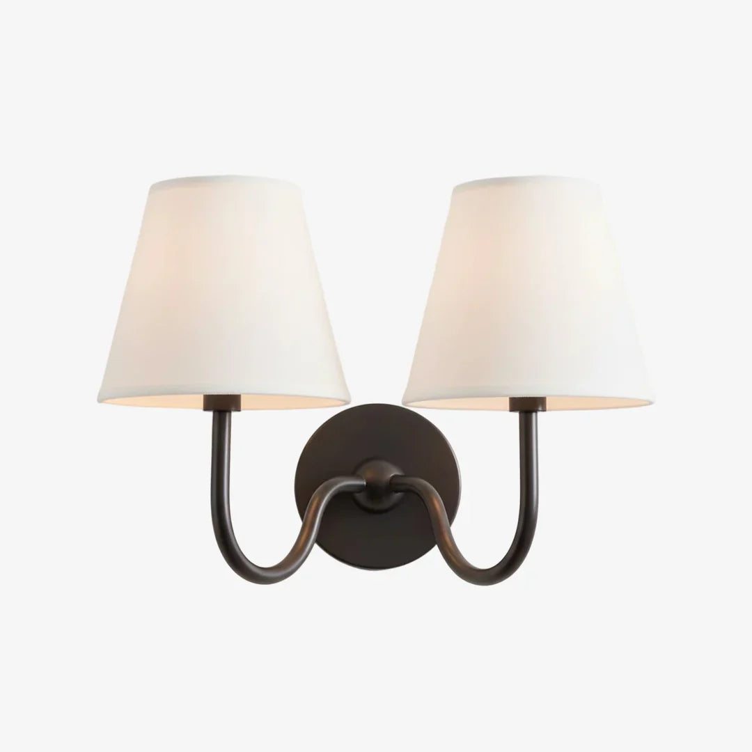 Wall sconce with two white lampshades on a white background