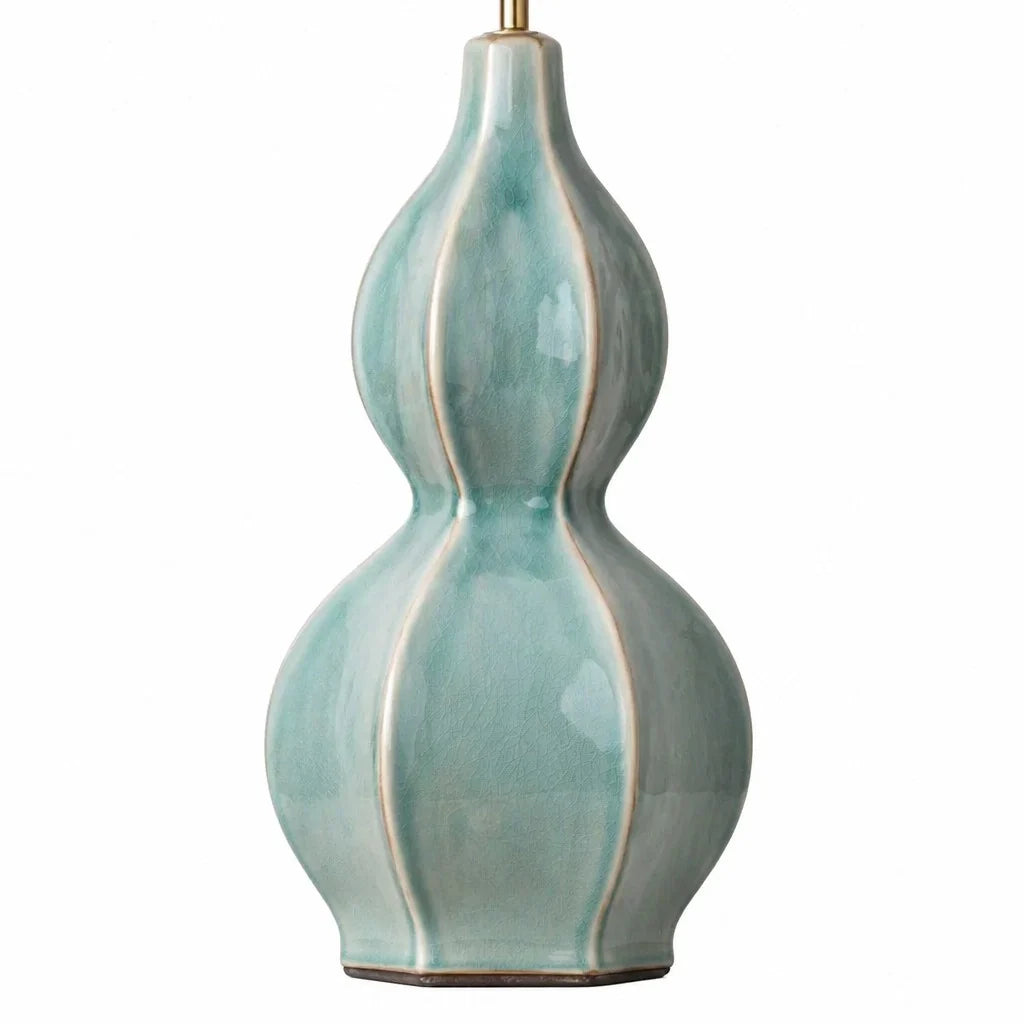 Teal ceramic lamp with a white background