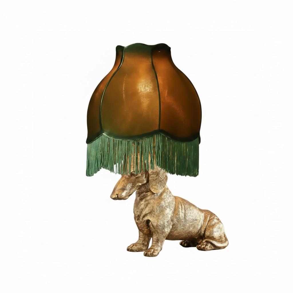 Decorative lamp with a green fringed shade on a white background