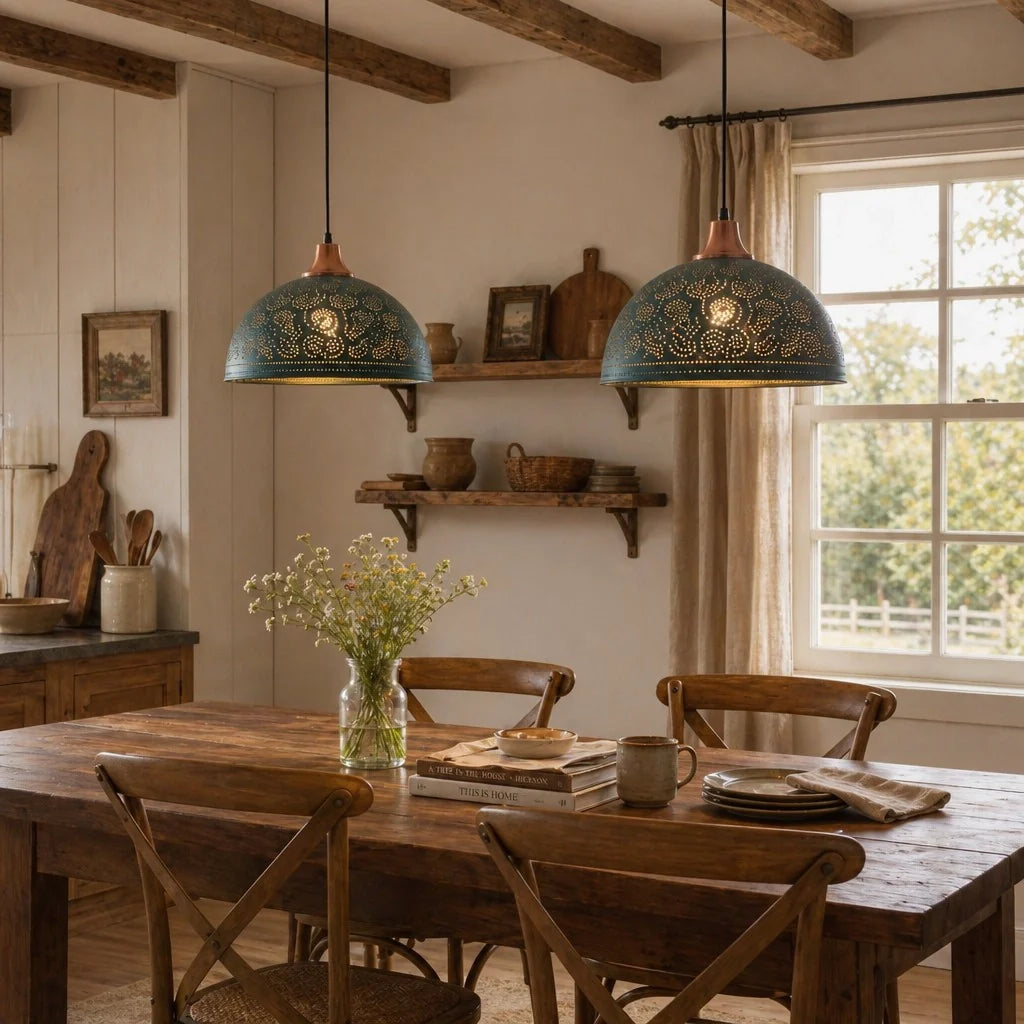 Two teal metal pendant lights with copper-toned shades hang over a rustic wooden dining table in a warm, traditional dining room.