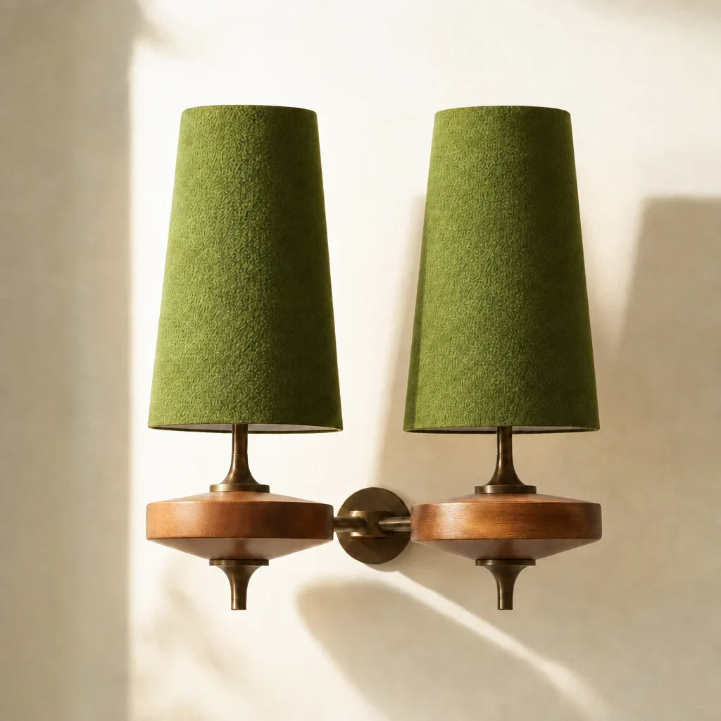 Pair of wall-mounted lamps with green shades and wooden bases on a neutral background