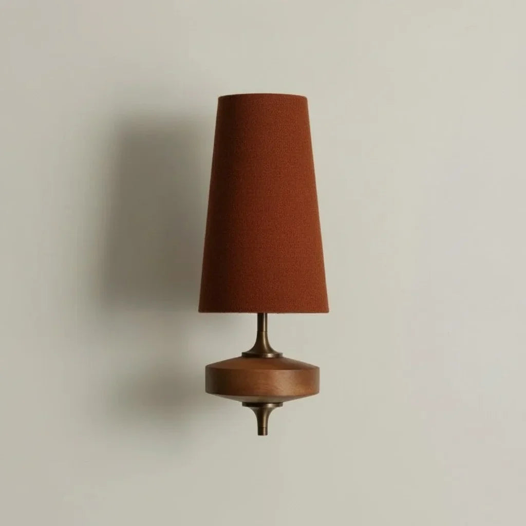 Wall-mounted lamp with a brown shade on a beige wall