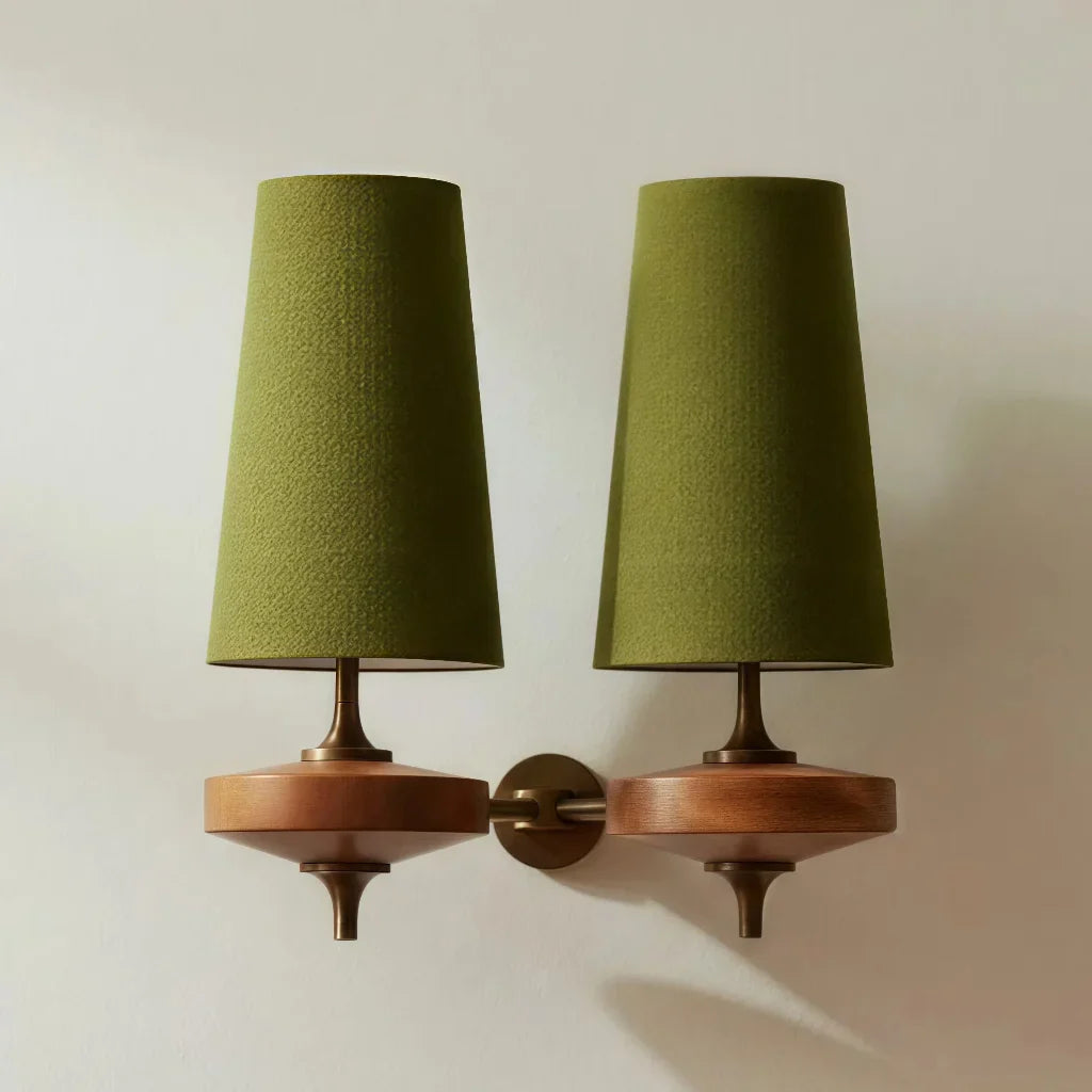 Pair of wall-mounted lamps with green shades and wooden bases on a neutral background