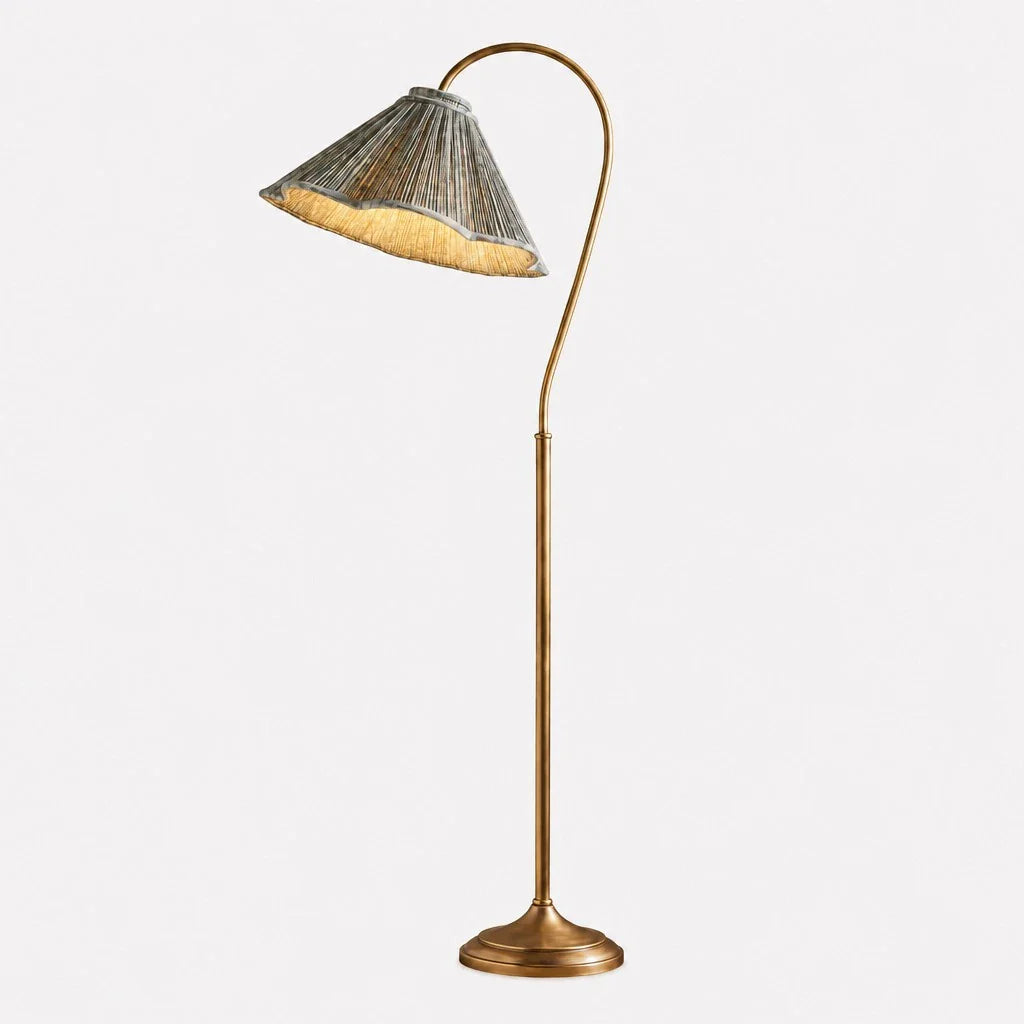 Floor lamp with a wicker shade on a white background